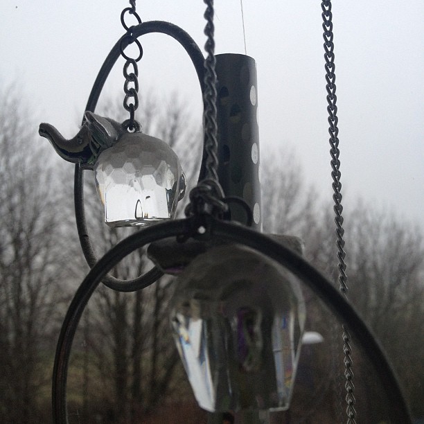 A photo I took on a grey day of my mums elephant chimes in the window. 