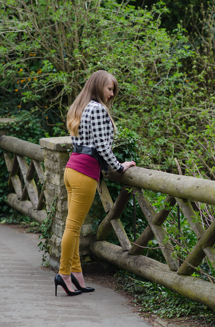 girl-leaning-over-bridge-park-tight-jeans